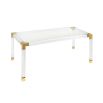 A stylish acrylic and brushed brass dining table 