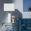 A glamorous solid marble table lamp with polished brass accents