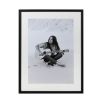 Black and white print of Joan Baez with guitar on the beach