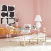 A stylish acrylic and brushed brass dining table 