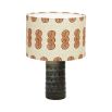 A luxury lampshade by Eva Sonaike with an orange African-inspired pattern