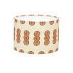 A luxury lampshade by Eva Sonaike with an orange African-inspired pattern