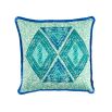 A vibrant cushion by Eva Sonaike with a turquoise African-inspired pattern and fringing