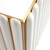 A retro-futuristic inspired cabinet in an ivory finish and brass base