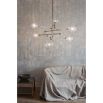 Industrial style 6 arm chandelier in a natural brass finish with 6 clear glass globe bulbs