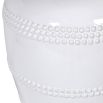 White ceramic table lamp with beading details around the base and beige linen shade