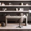 Striking three drawer desk in a grey wood finish with brass accents