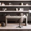 Striking three drawer desk in a grey wood finish with brass accents