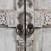 ornate cabinet with two doors in a light-washed wood