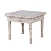 washed wood side table with intricate carved detailing