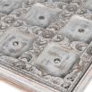 washed wood side table with intricate carved detailing