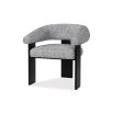 A contemporary armchair by Liang & Eimil with a boucle upholstery and statement legs