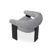 A contemporary armchair by Liang & Eimil with a boucle upholstery and statement legs