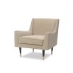 Light brown lounge chair featuring legs of solid wood capped with polished brass cups