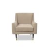 Light brown lounge chair featuring legs of solid wood capped with polished brass cups