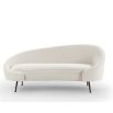 A contemporary curved sofa by Liang & Eimil with a beautiful boucle upholstery