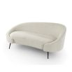 A contemporary curved sofa by Liang & Eimil with a beautiful boucle upholstery