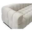 A contemporary sofa with a boucle upholstery and deep channel stitching design