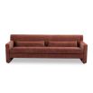 A modern sofa with a statement rust upholstery and scatter cushions