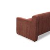 A modern sofa with a statement rust upholstery and scatter cushions