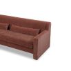 A modern sofa with a statement rust upholstery and scatter cushions