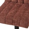 Square bar stool with upholstered in rust coloured fabric with fluting details