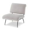 Grey velvet armchair with rounded top and base