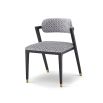 Black and white patterned chair with slanted back legs and brass capped feet