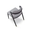 Black and white patterned chair with slanted back legs and brass capped feet