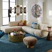 A glamorous left arm facing sectional sofa with an Olympus Ivory bouclé upholstery, deep channelled cushions and capsule-shaped arms