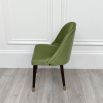 A set of six dining chairs by Laskasas with a green velvet upholstery and elevated on dark, wooden legs with golden caps