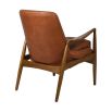 Luxurious mid-century style armchair with rust coloured leather seat 
