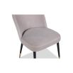 Light grey upholstered dining chair with tapered black legs with brass caps