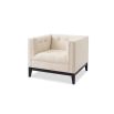A sophisticated armchair by Liang & Eimil with a neutral upholstery and buttoned design