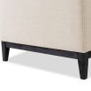 A sophisticated armchair by Liang & Eimil with a neutral upholstery and buttoned design