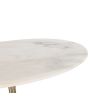White marble dining table sitting atop brass base