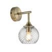 Wall sconce with singular twisted glass globe and brass fixture