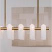 Contemporary natural brass finish chandelier with a colonnade of translucent glass lampshades 