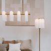Contemporary natural brass finish chandelier with a colonnade of translucent glass lampshades 