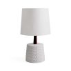 A satin glazed table lamp with relief decor and natural walnut wood neck with a white linen shade