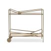 A luxury bar cart by Caracole with a glamorous gold finish