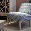 Blue and white patterned chair with relaxed silhouette