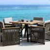 A stylish outdoor dining chair with grey strapping and bespoke sunbrella cushions 