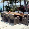 A stylish outdoor dining chair with grey strapping and bespoke sunbrella cushions 