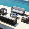 A luxury outdoor sofa from Willow's Outdoor collection with a bespoke sunbrella cushion upholstery and grey strapping