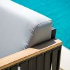 A luxury outdoor sofa from Willow's Outdoor collection with a bespoke sunbrella cushion upholstery and grey strapping