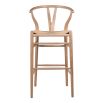 A stylish Scandinavian-inspired bar stool with an open back design and rattan seat