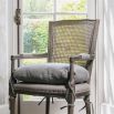 Vintage style chair with rattan backrest, linen chair cushion and arms