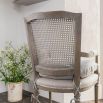 Vintage style chair with rattan backrest, linen chair cushion and arms
