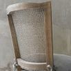French-inspired dining chair with rattan-style back and removable seat cushion